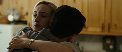 a woman hugging a man in a kitchen