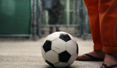 a person standing next to a soccer ball