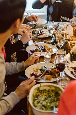 a group of people sitting around a dinner table