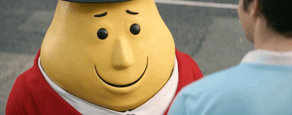 a man standing next to a yellow cartoon character