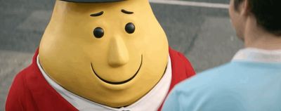 a man standing next to a yellow cartoon character