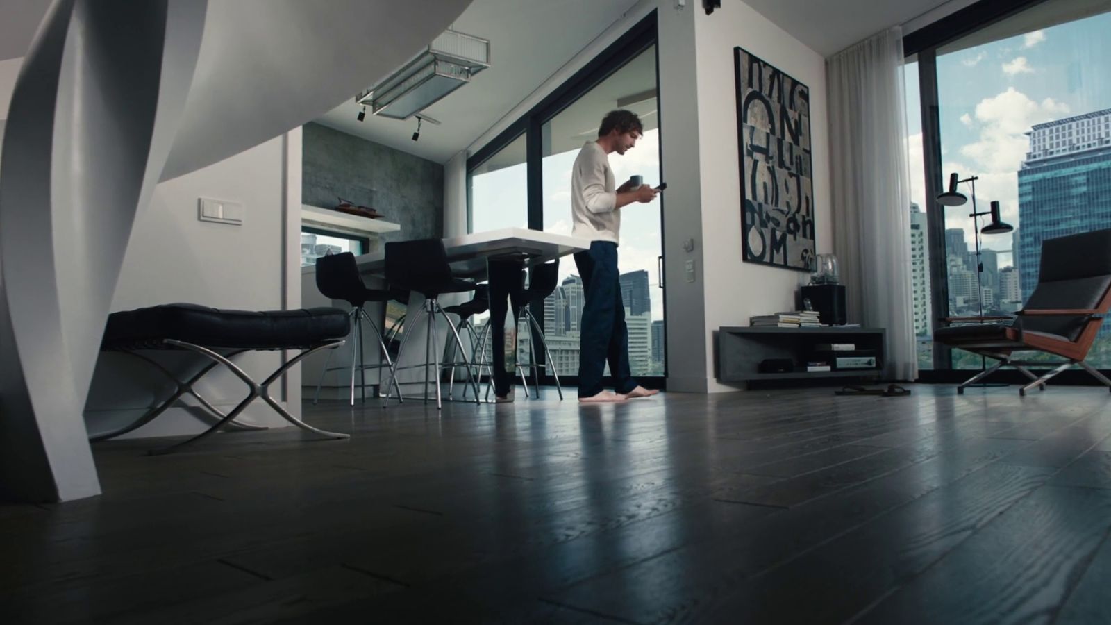 a man standing in a living room next to a window