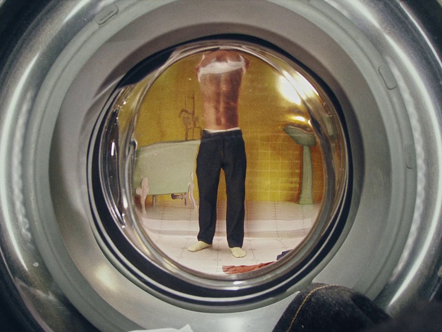 a reflection of a man in a washing machine