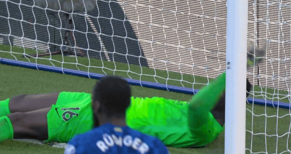 a man laying on the ground next to a soccer ball