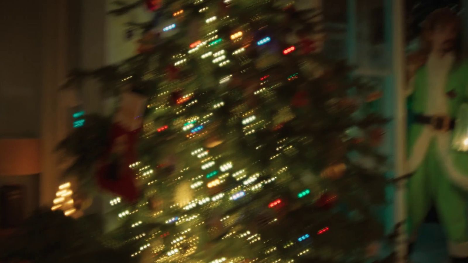 a christmas tree is lit up in a living room