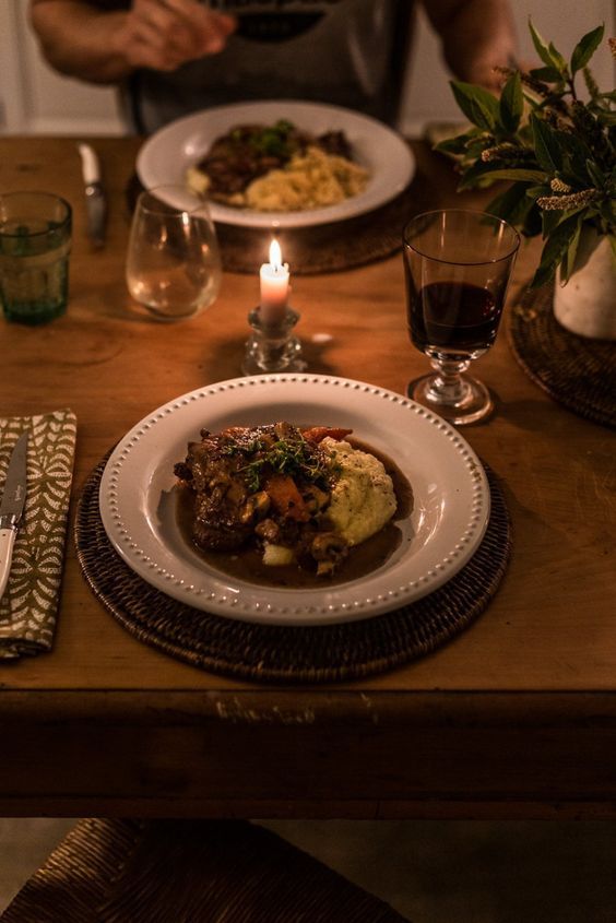 a person sitting at a table with a plate of food