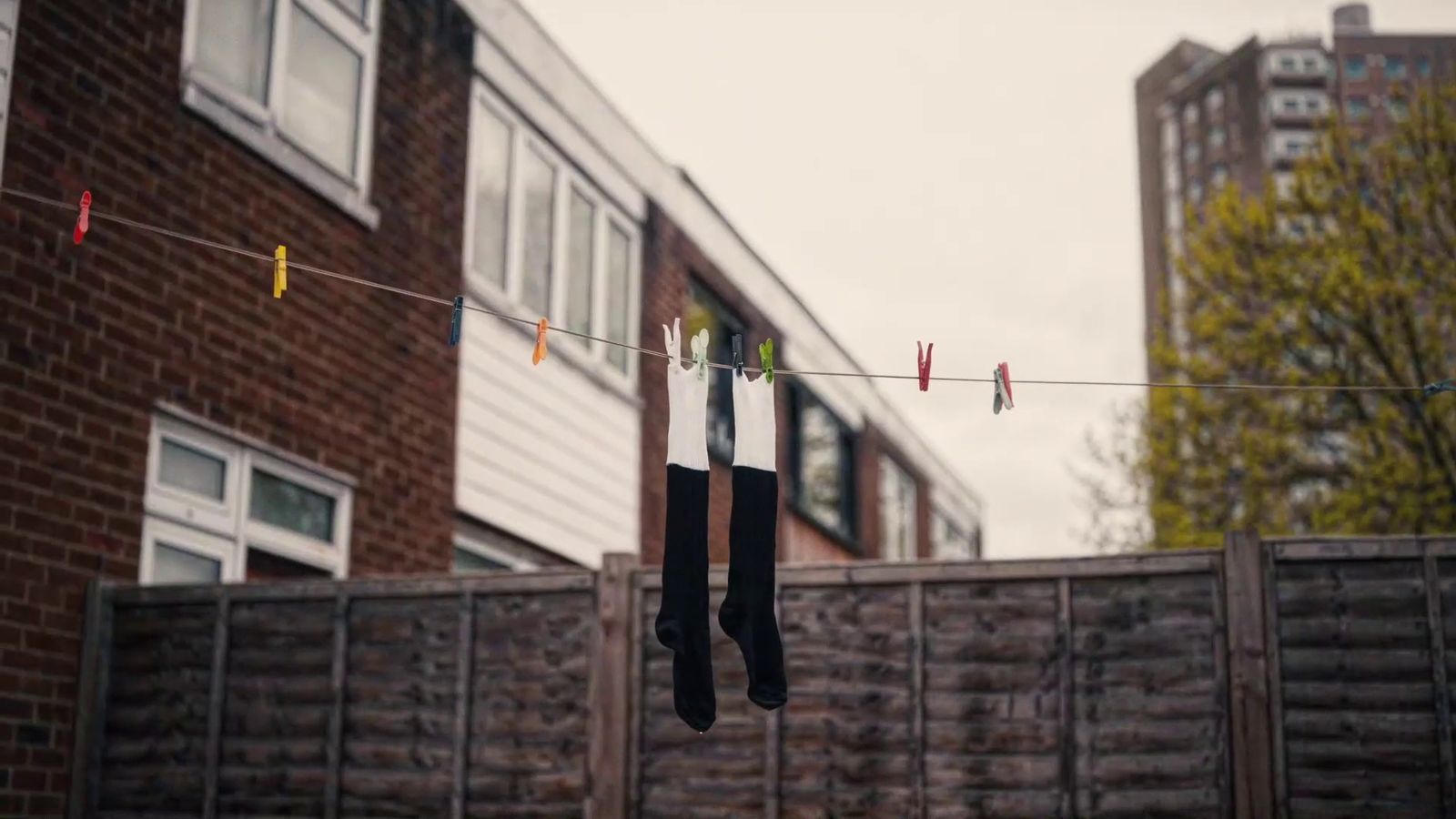 clothes hanging on a clothes line in front of a brick building