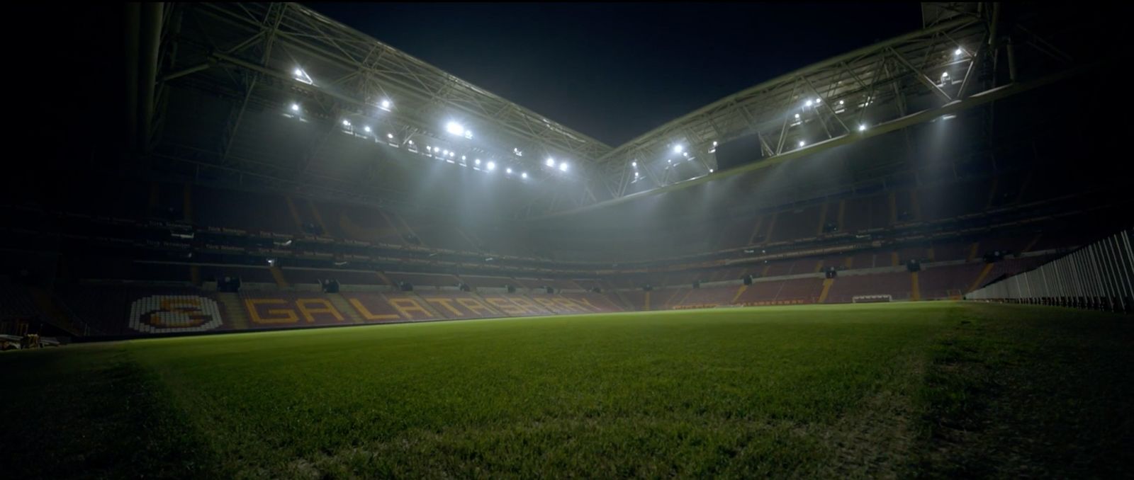 a soccer field with lights on at night