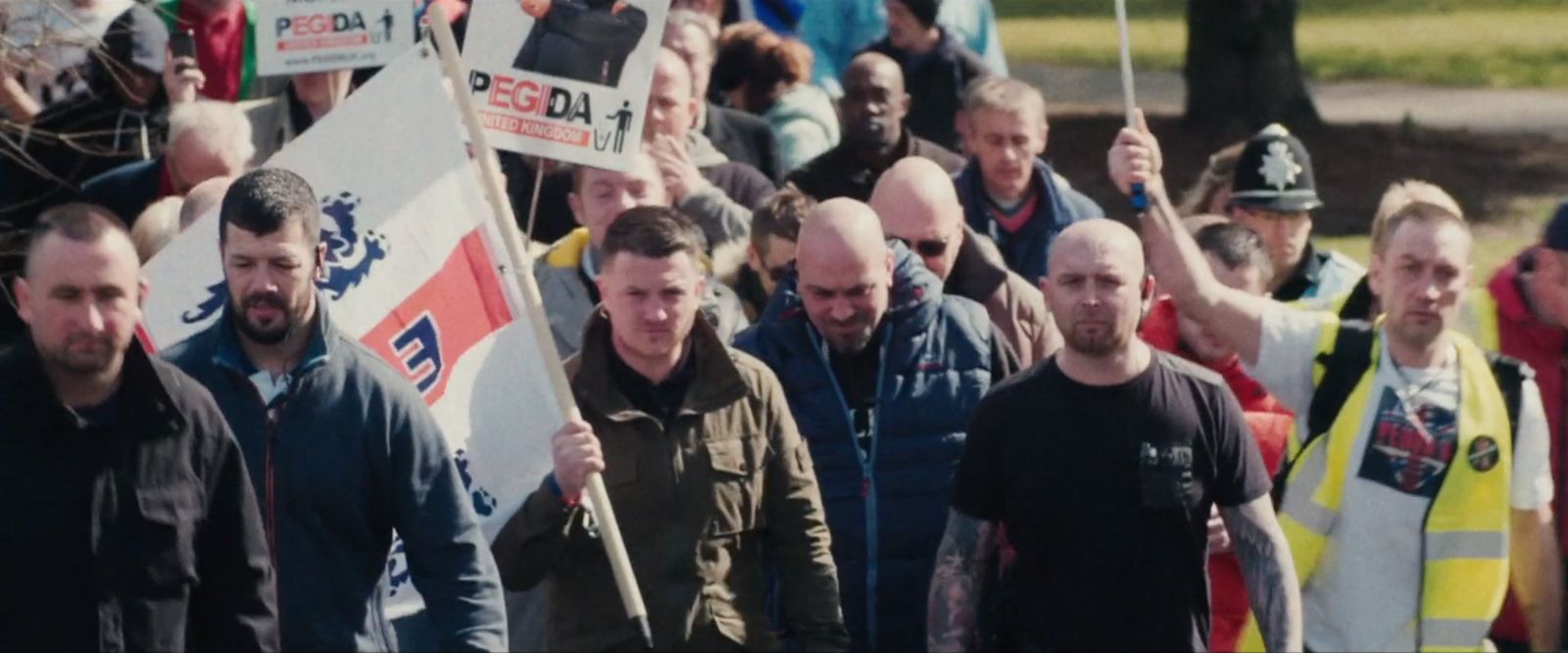 a large group of people walking down a street