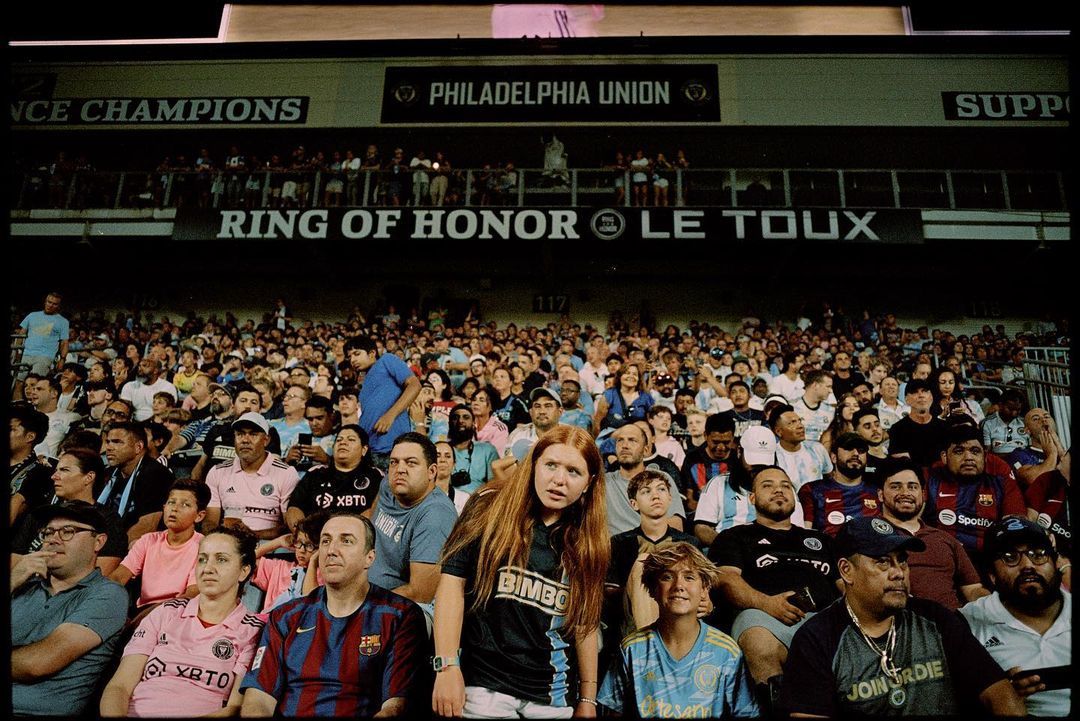 a large crowd of people sitting in a stadium