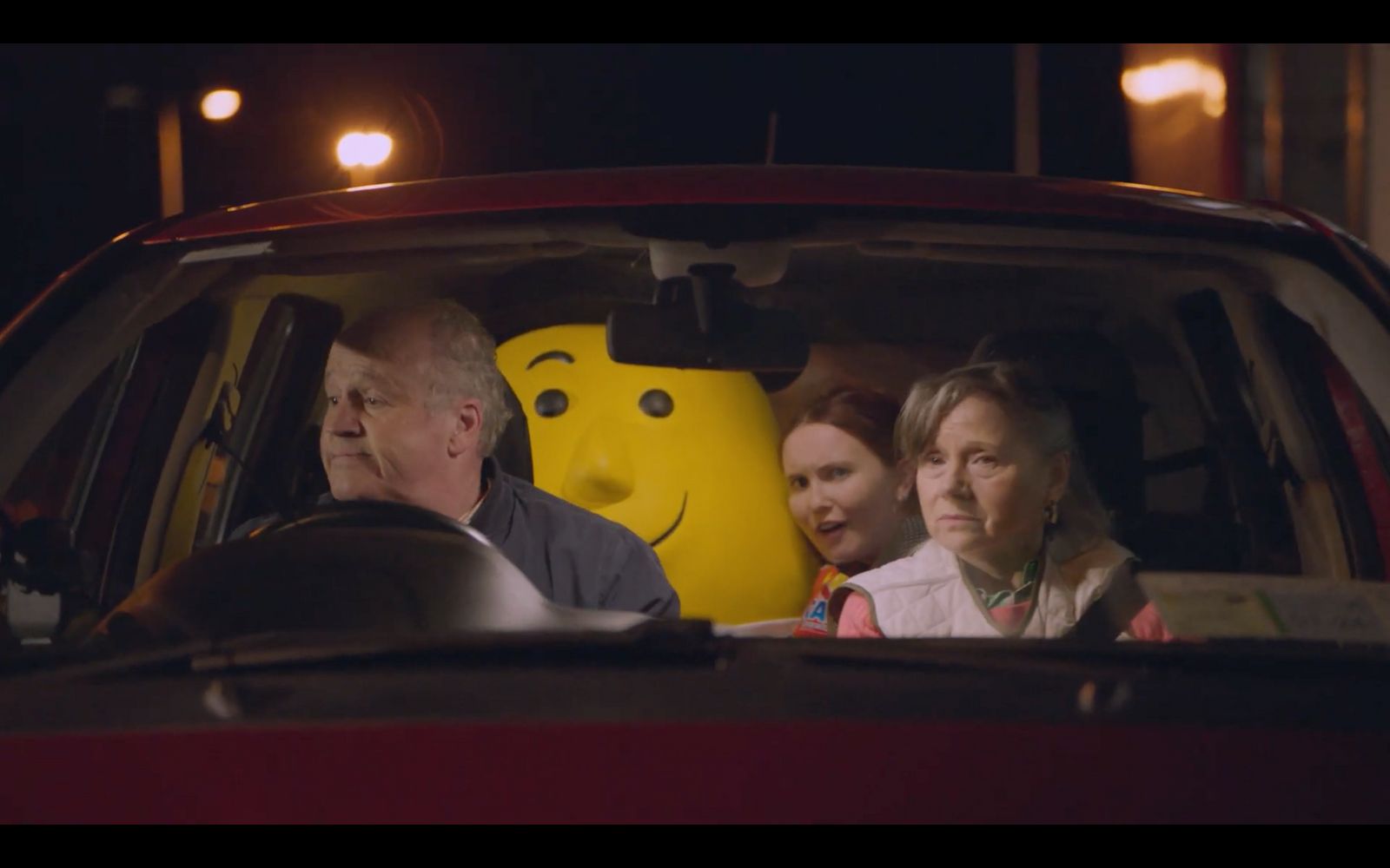 a group of people sitting in the back of a car