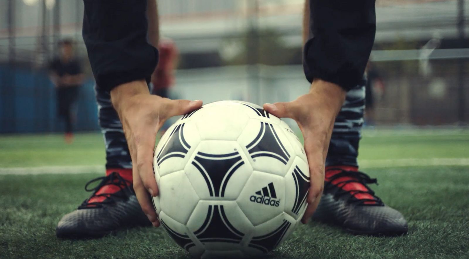 a person holding a soccer ball on a field