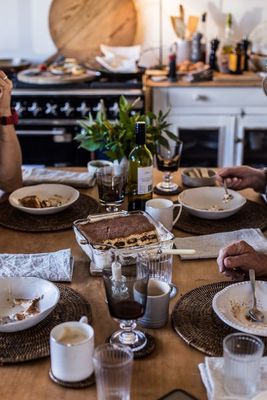 a couple of people sitting at a table eating food