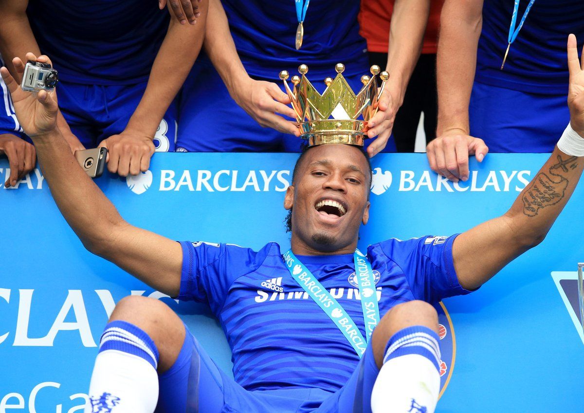 a man sitting on the ground with a crown on his head