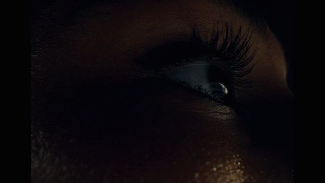 a close up of a person's eye with a dark background