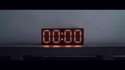 a digital clock sitting on top of a table