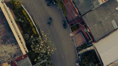 an aerial view of a street with a motorcycle parked on it