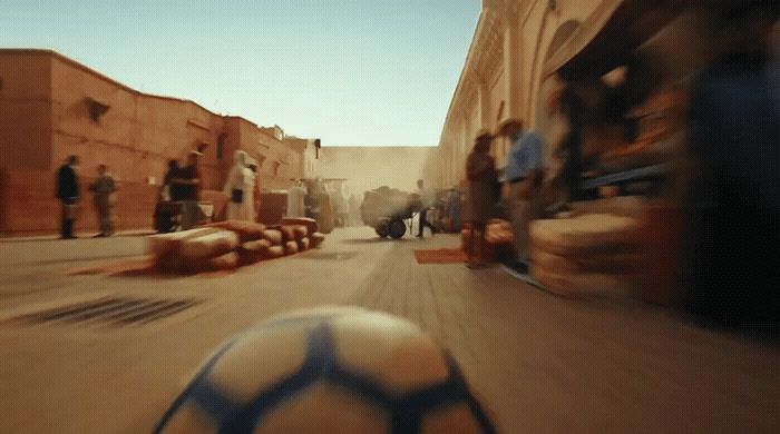 a soccer ball sitting in the middle of a street