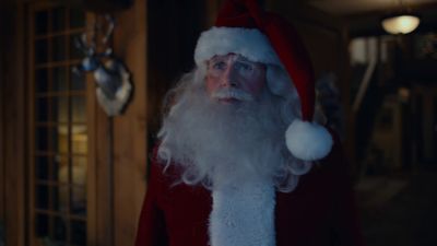 a man dressed as santa claus in a living room