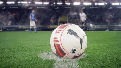 a soccer ball sitting on top of a lush green field