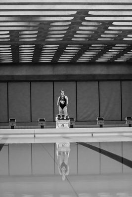 a man standing on top of a swimming pool