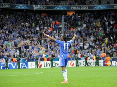 a soccer player celebrating a goal in front of a crowd