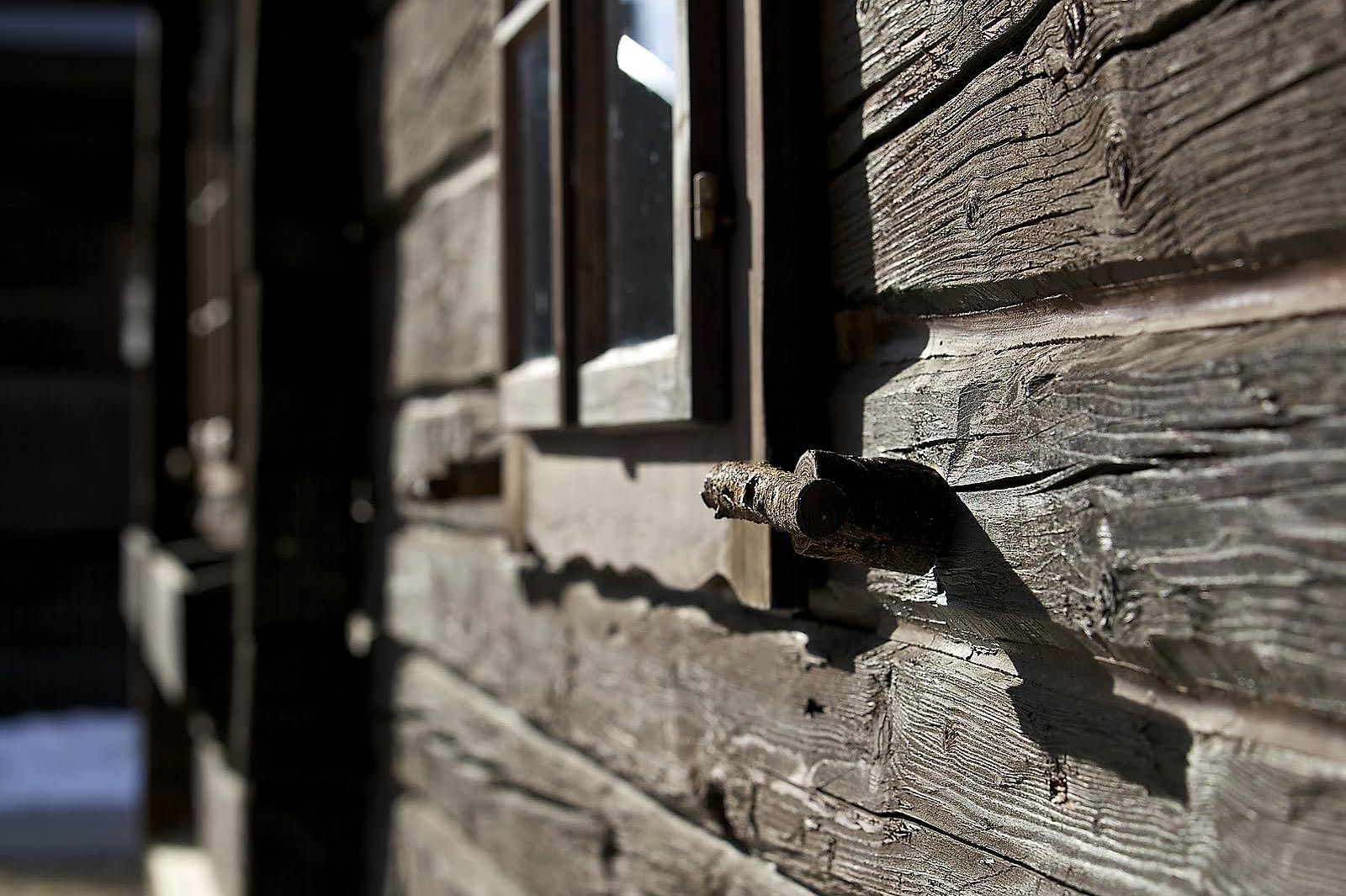 a close up of a wooden building with a window