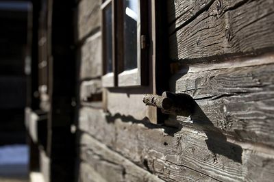 a close up of a wooden building with a window