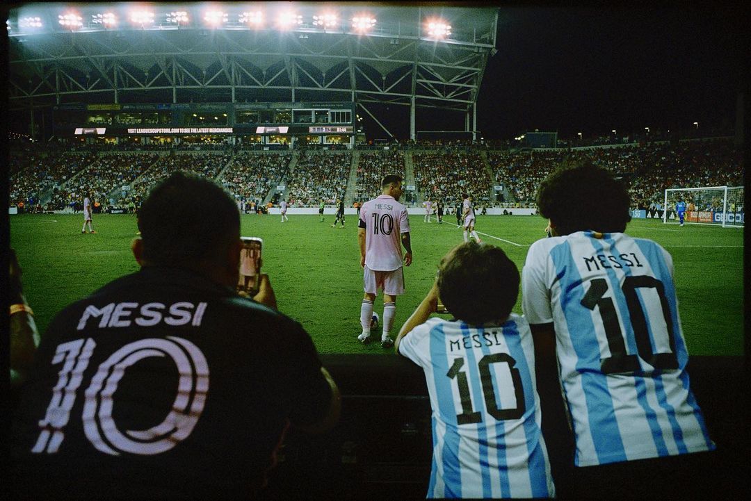 a group of men standing on top of a soccer field