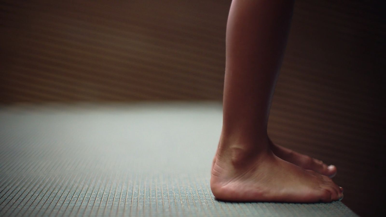 a close up of a person's bare feet on a bed