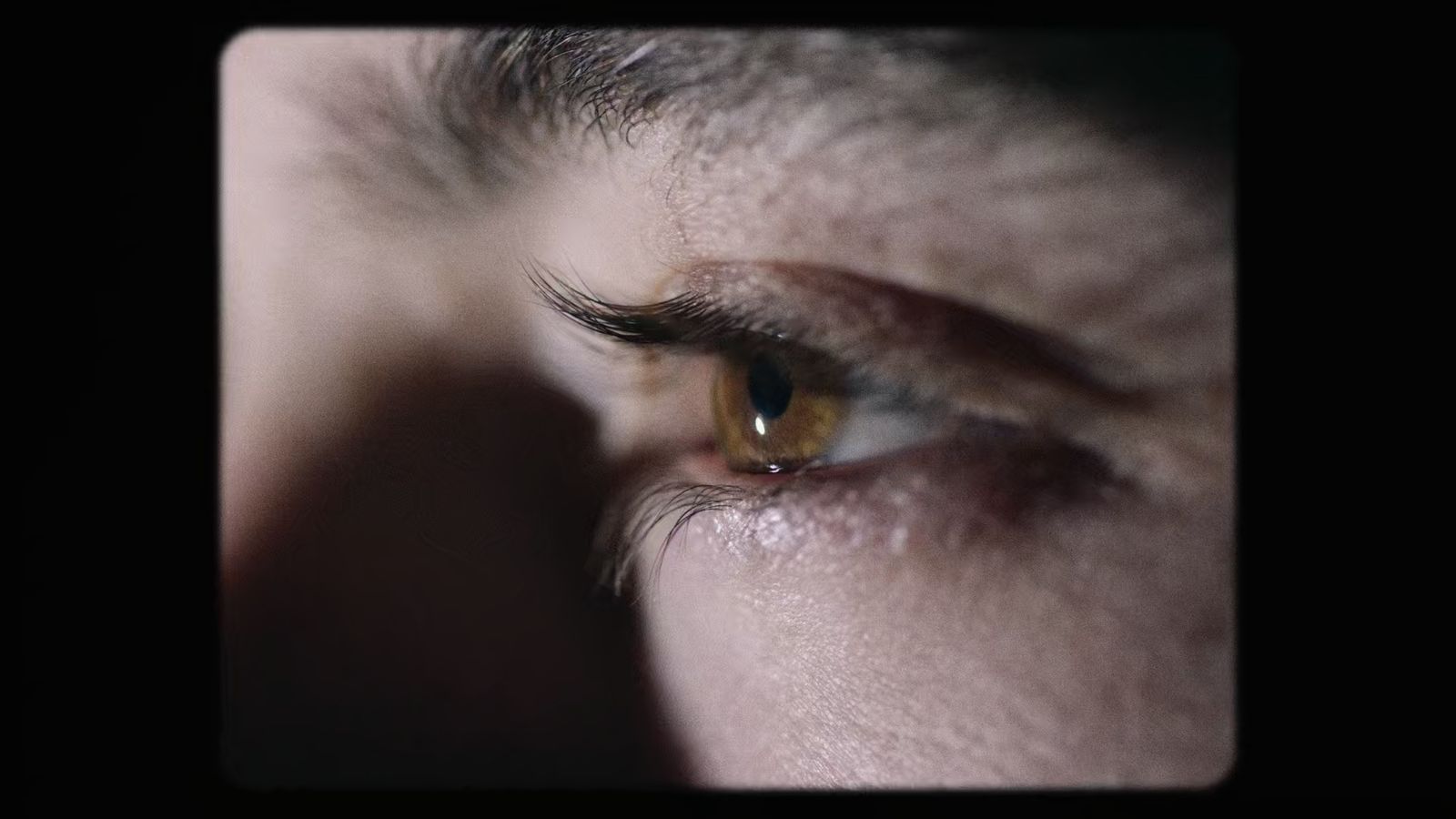 a close up of a person's eye with a dark background