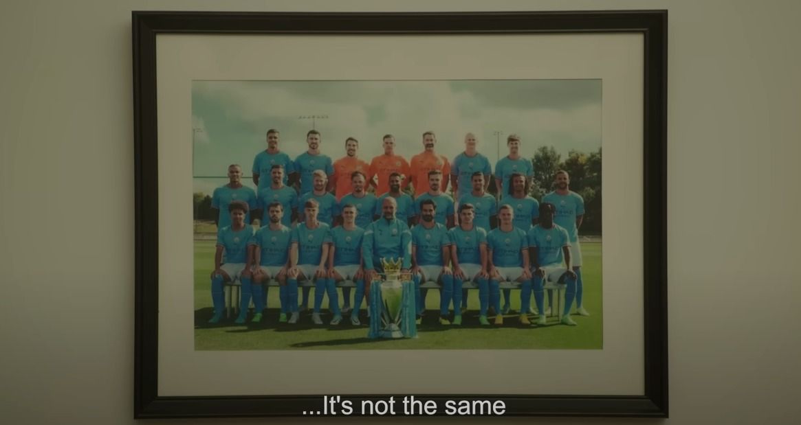 a picture of a soccer team is hanging on the wall