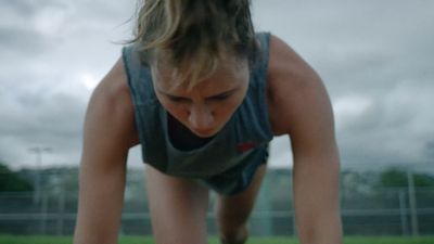 a woman doing a push up on a skateboard