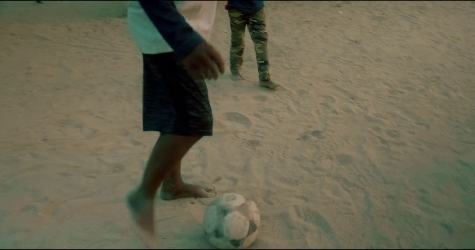 a couple of people that are playing with a soccer ball