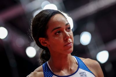 a close up of a female basketball player with a serious look on her face