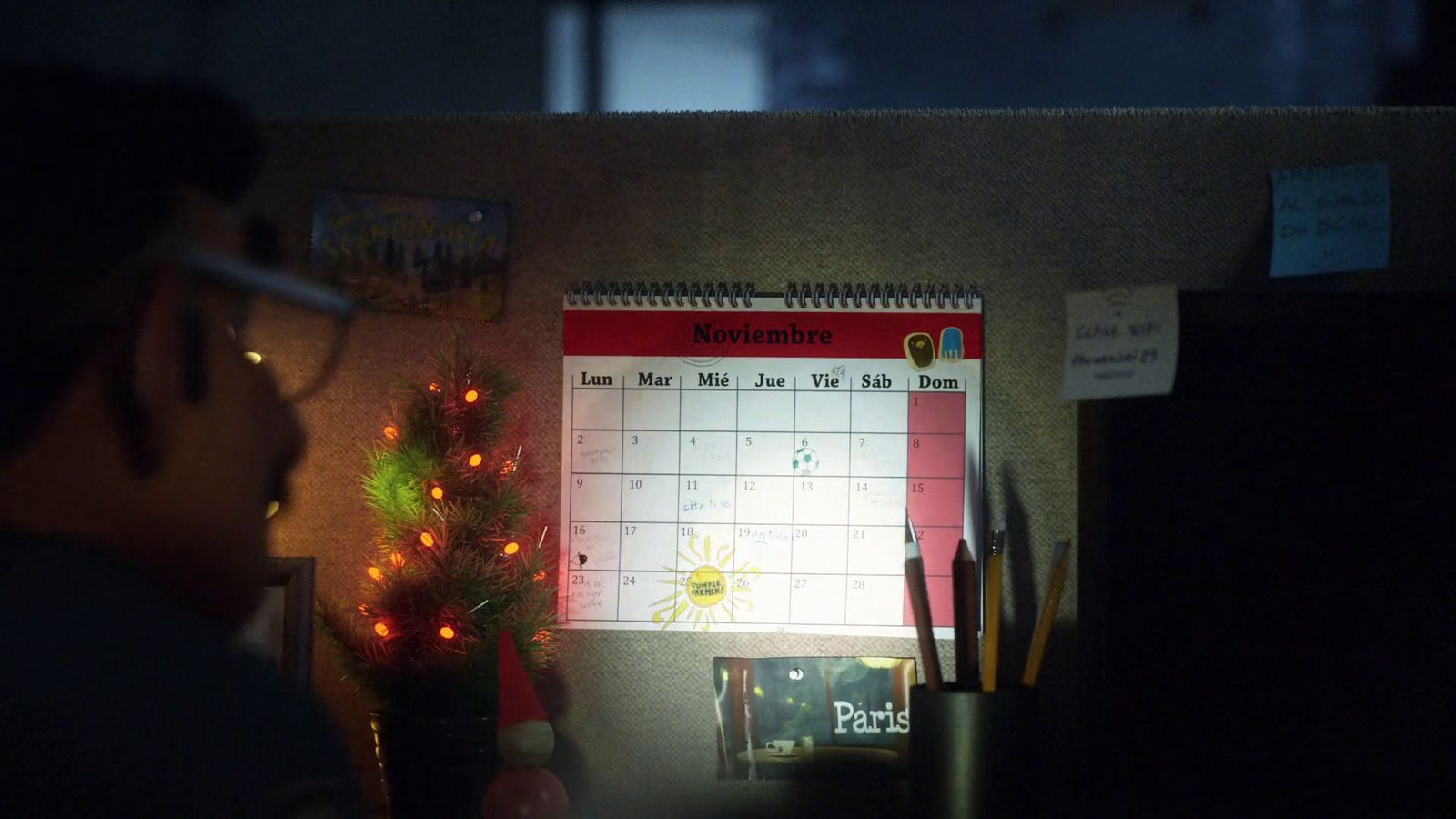 a man is looking at a calendar on a wall