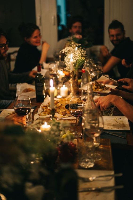 a group of people sitting around a dinner table