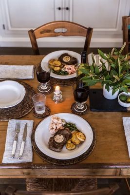 a wooden table topped with plates of food