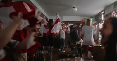 a group of people standing in a room with flags