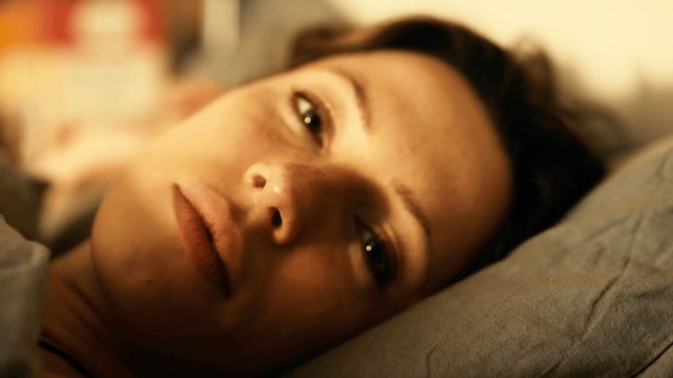 a close up of a person laying on a bed