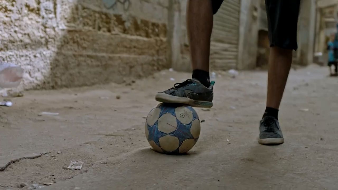 a person standing on top of a soccer ball