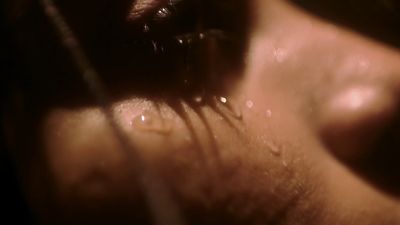 a close up of a person's eye with water drops on it