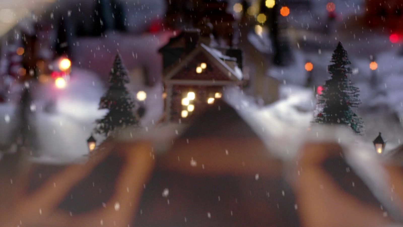 a blurry photo of a snowy street with a small house