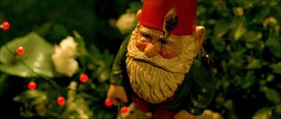 a close up of a gnome figurine in a garden