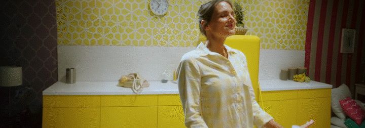 a woman standing in a bathroom next to a sink