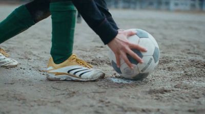 a person holding a soccer ball in their hand