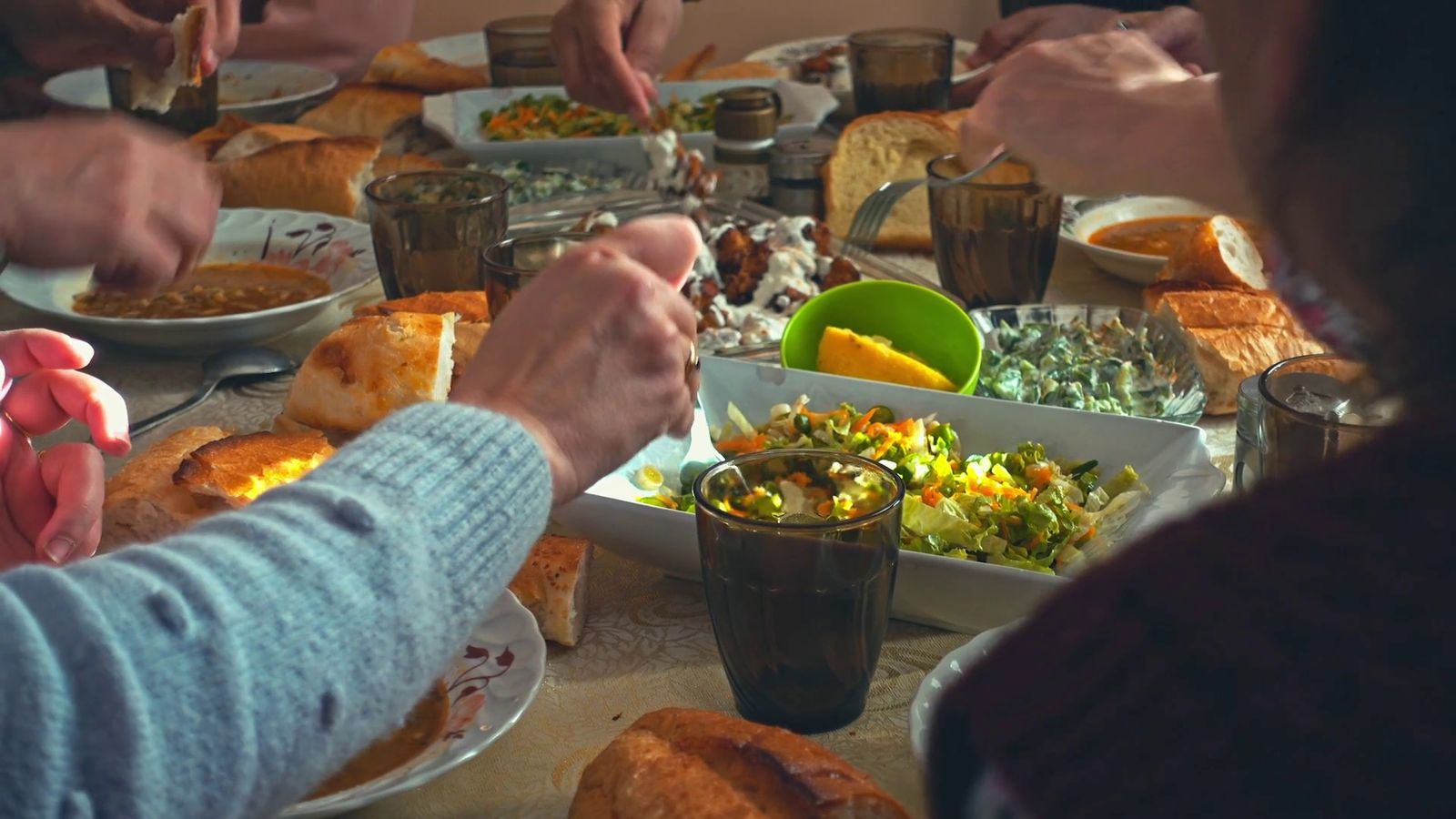 a group of people sitting around a table eating food