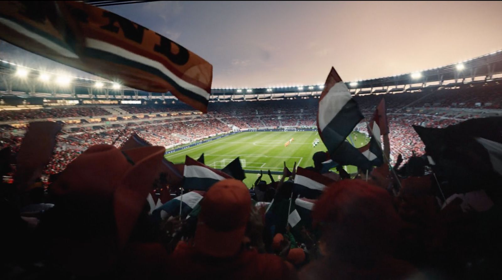 a stadium filled with lots of people holding flags