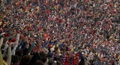 a large crowd of people standing in a stadium