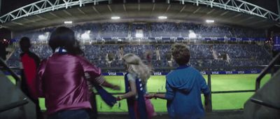 a group of people standing in front of a stadium